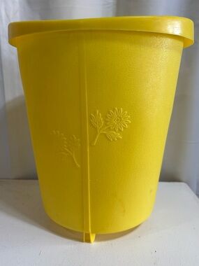 Vintage bright yellow garbage can